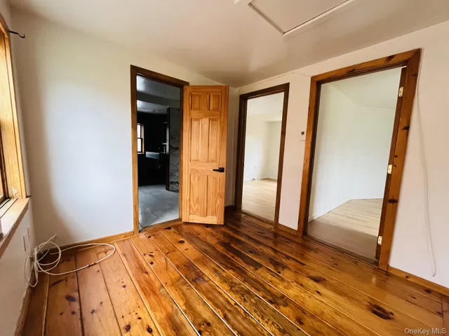 a view of front door with wooden floor