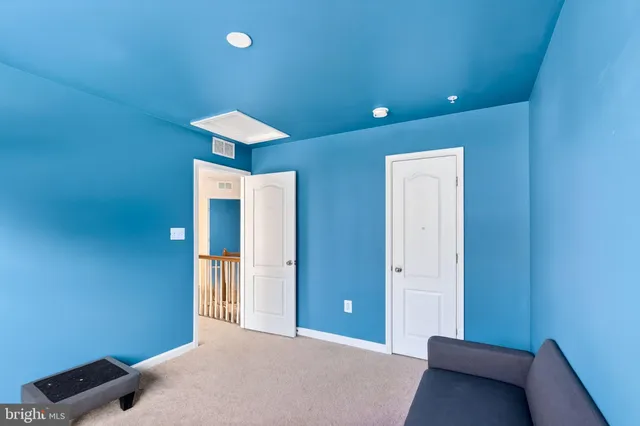 a bedroom with a bed and a lamp