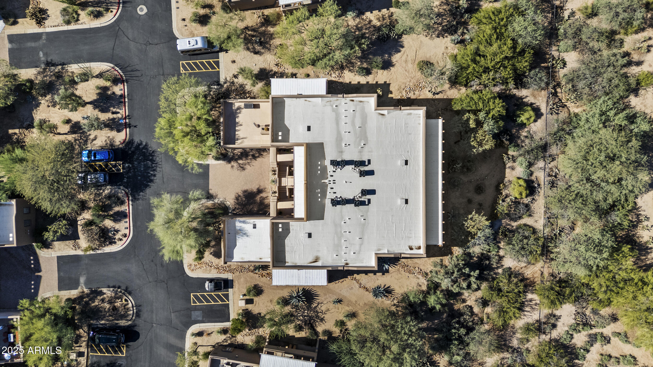36601 North Mule Train Road, Unit D18 Carefree, AZ 85377 - Photo 42 of 57 an aerial view of a house with a yard and large trees