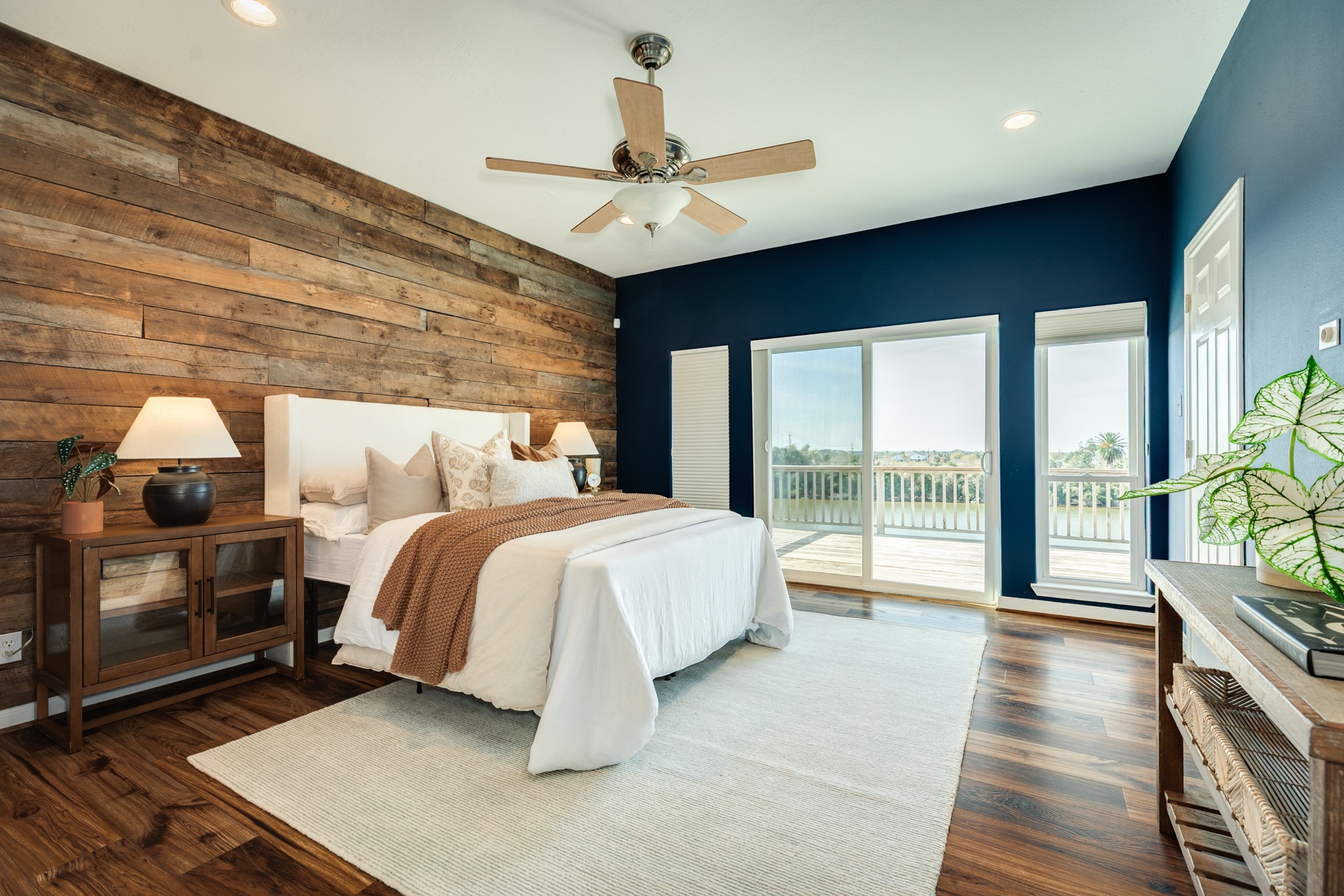 11648 Zingelmann Road Galveston, TX 77554 - Photo 20 of 39 a spacious bedroom with a balcony a bed and large window