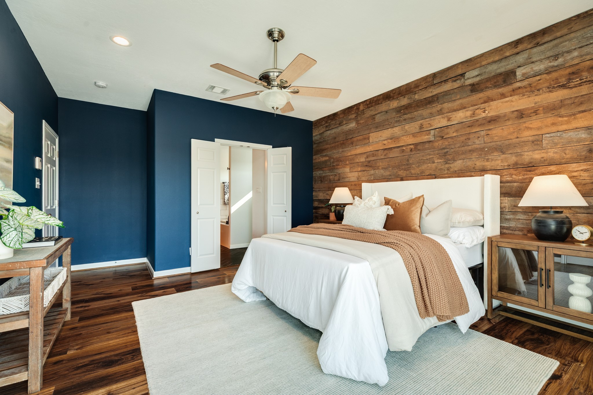 11648 Zingelmann Road Galveston, TX 77554 - Photo 21 of 39 a bedroom with a bed a mirror and desk