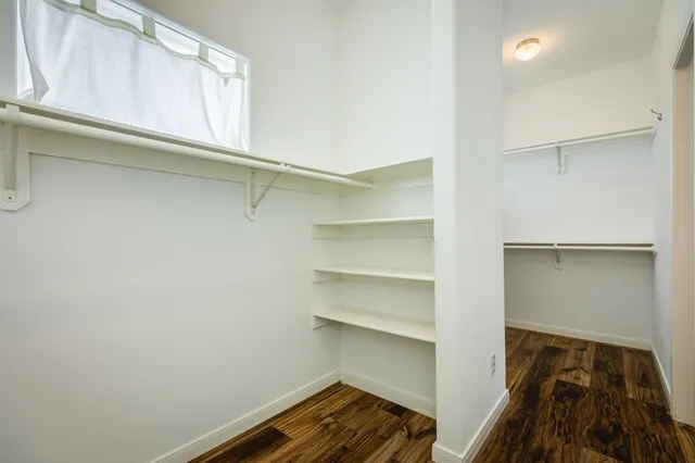 a view of walk in closet with empty racks