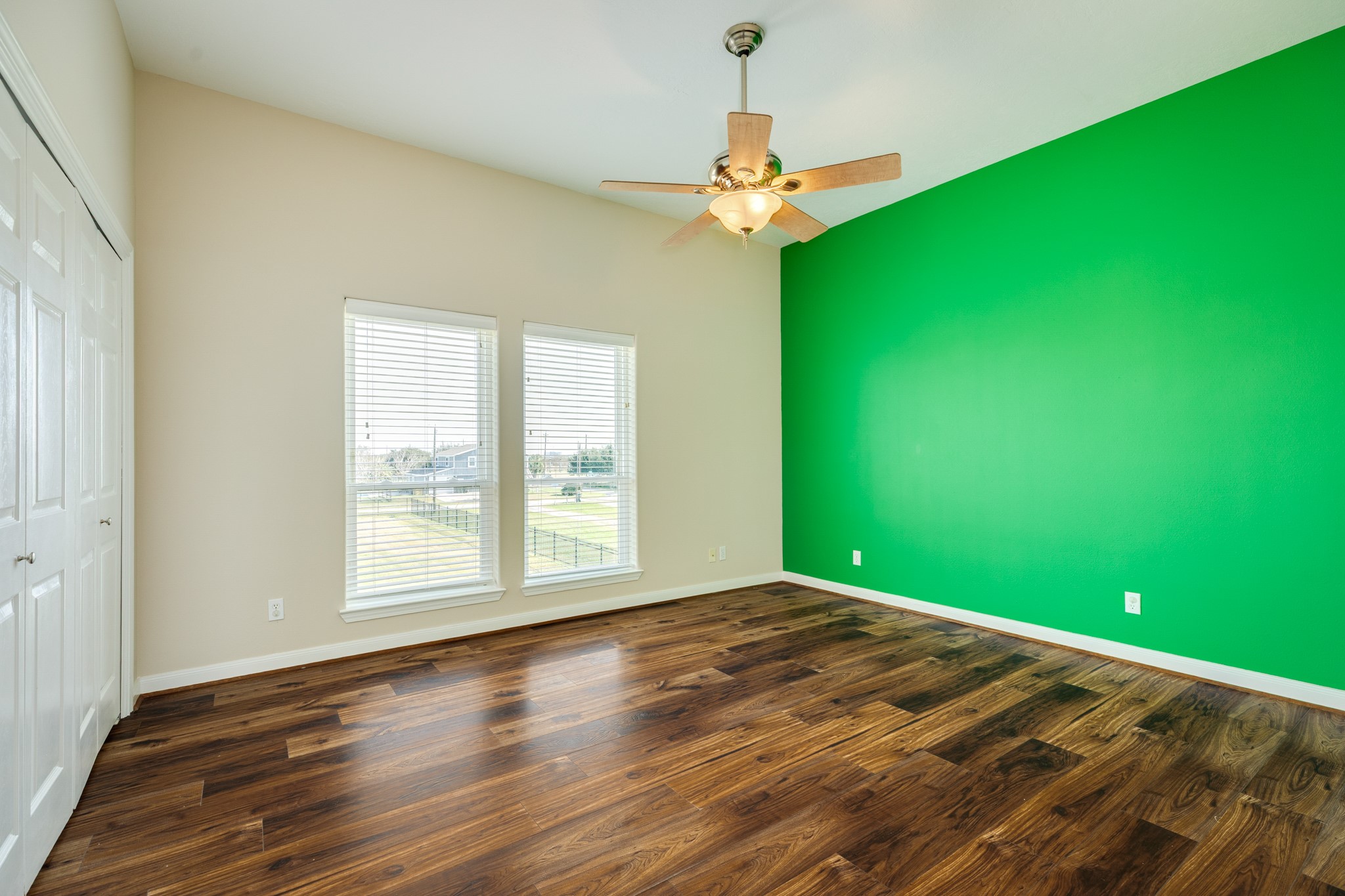 11648 Zingelmann Road Galveston, TX 77554 - Photo 27 of 39 a view of empty room with window and wooden floor