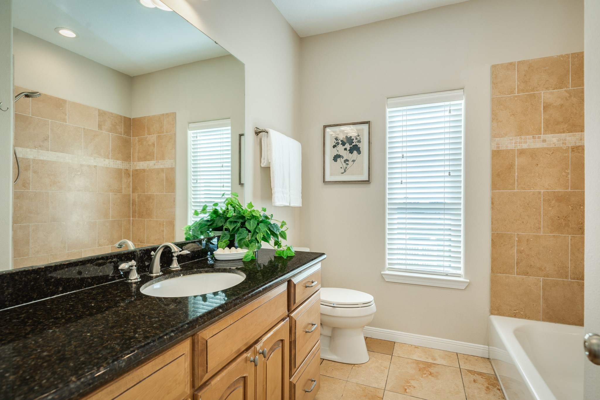 11648 Zingelmann Road Galveston, TX 77554 - Photo 28 of 39 a bathroom with a granite countertop sink toilet and shower