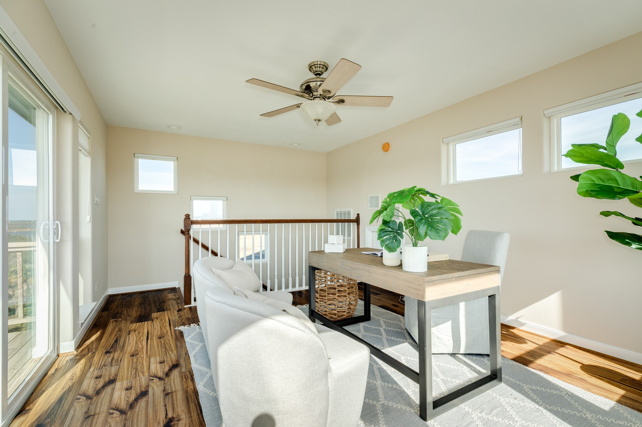 11648 Zingelmann Road Galveston, TX 77554 - Photo 32 of 39 a living room with wooden floor furniture and a potted plant