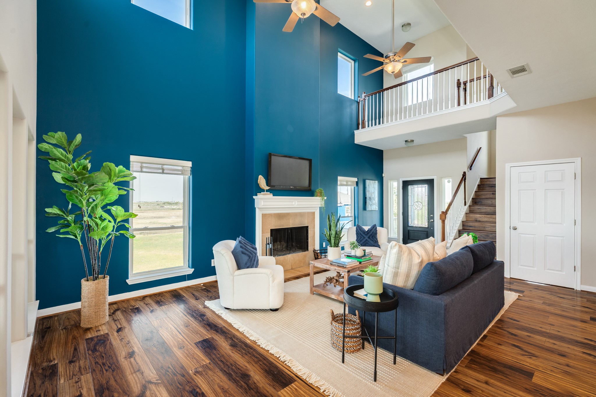 11648 Zingelmann Road Galveston, TX 77554 - Photo 8 of 39 a living room with furniture a fireplace and a potted plant
