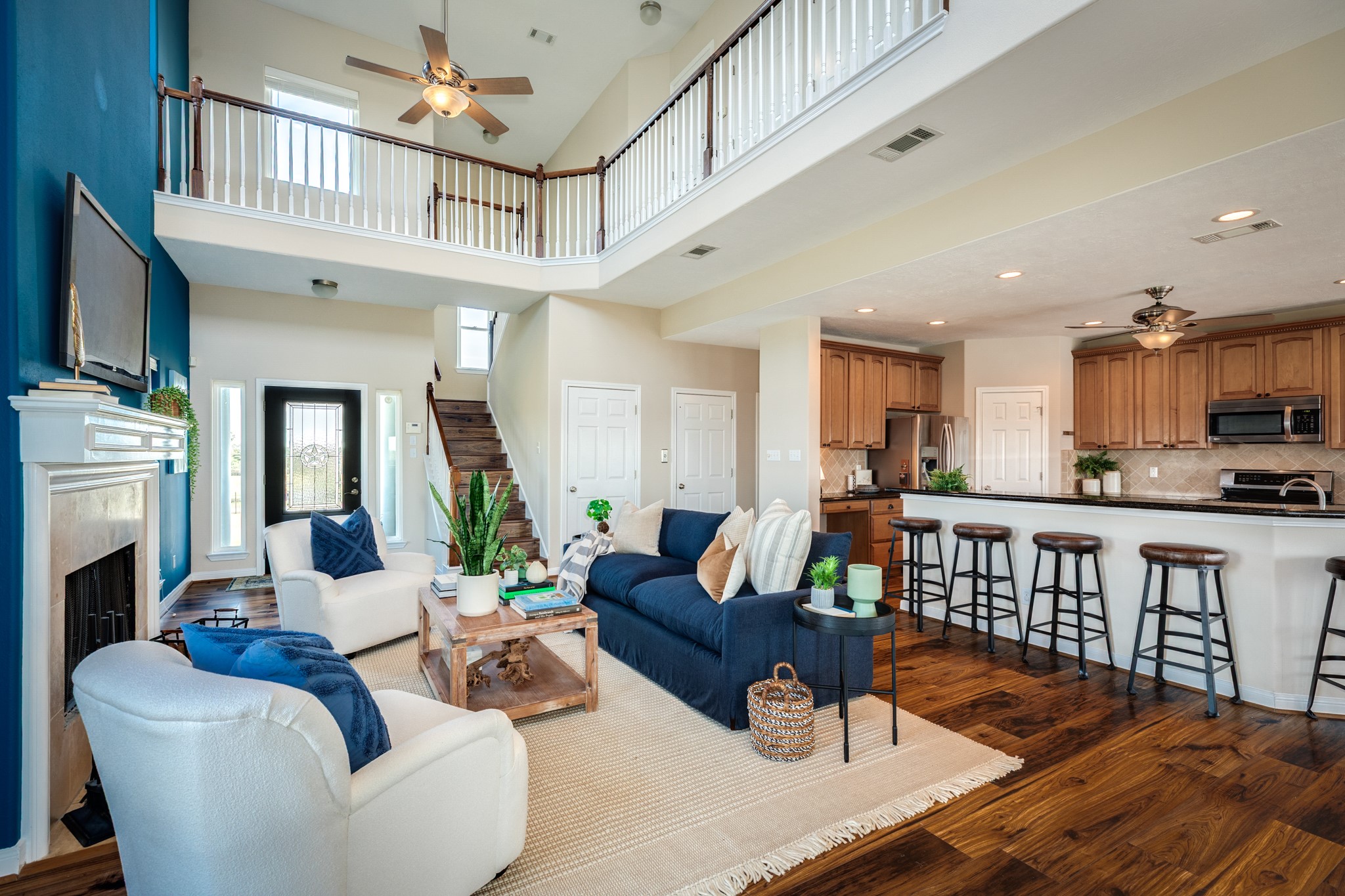 11648 Zingelmann Road Galveston, TX 77554 - Photo 9 of 39 a living room with fireplace furniture and a wooden floor