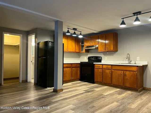 a kitchen with stainless steel appliances granite countertop a refrigerator and a sink