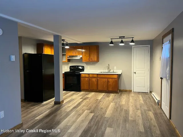 a large kitchen with cabinets a sink and stainless steel appliances