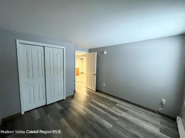 a view of an empty room and wooden floor