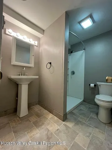 a bathroom with a sink toilet and shower