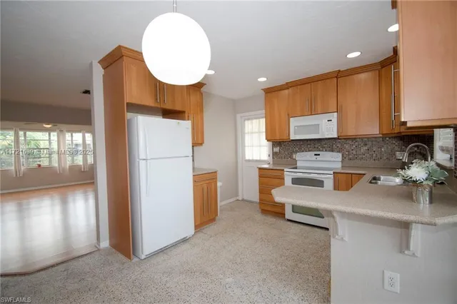 a kitchen with stainless steel appliances a stove refrigerator sink and cabinets