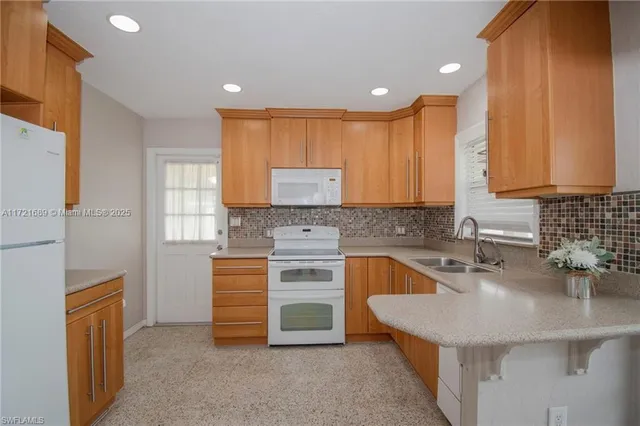 a kitchen with stainless steel appliances granite countertop a sink stove and cabinets