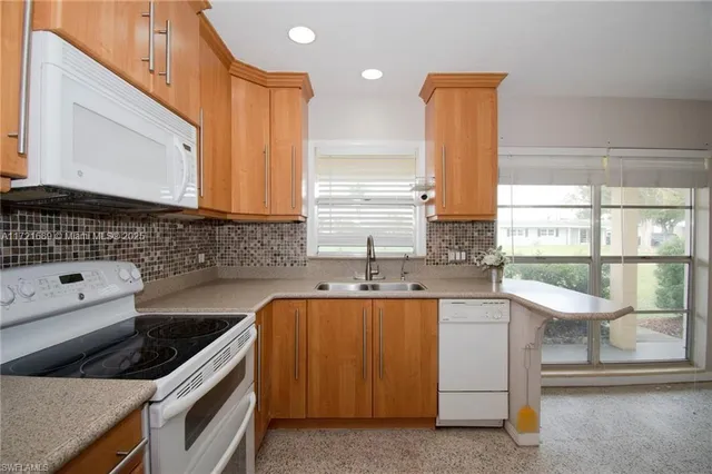 a kitchen with a sink stove and cabinets