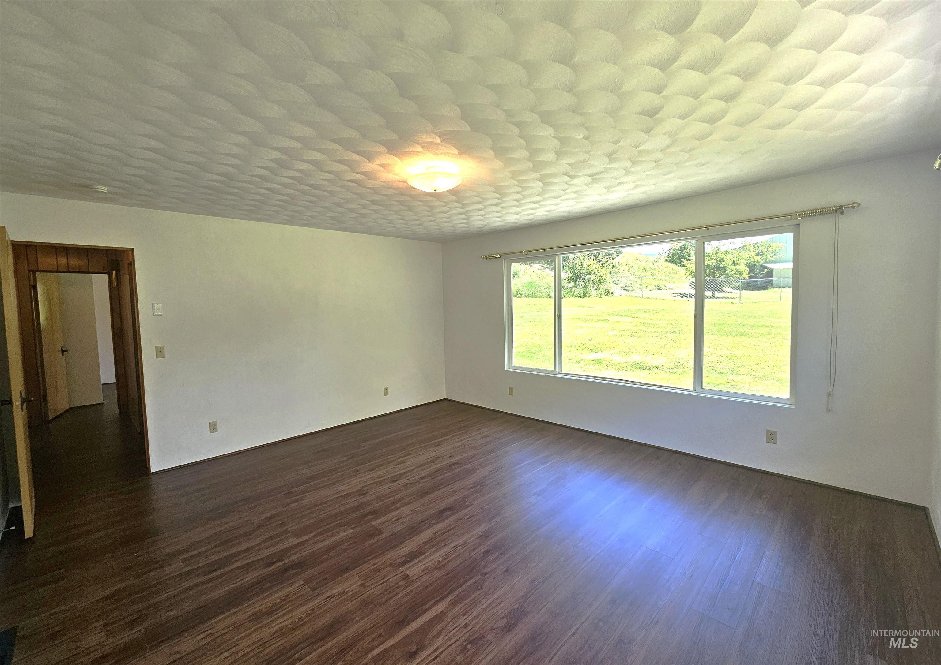 29865 Mission Creek Road Culdesac, ID 83524 - Photo 29 of 43 Interior room featuring wood-finish flooring, white walls, and a textured ceiling