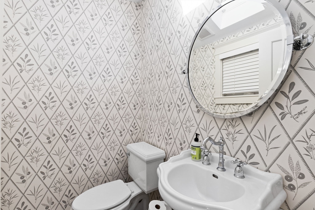 54 Elm Street Hingham, MA 02043 - Photo 13 of 33 a bathroom with a sink mirror and toilet