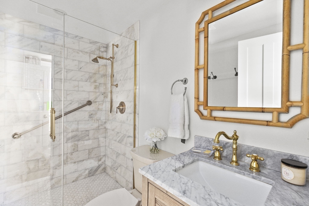 54 Elm Street Hingham, MA 02043 - Photo 16 of 33 a bathroom with a granite countertop sink a toilet and shower