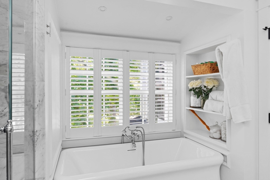54 Elm Street Hingham, MA 02043 - Photo 20 of 33 a bathroom with a bathtub and window
