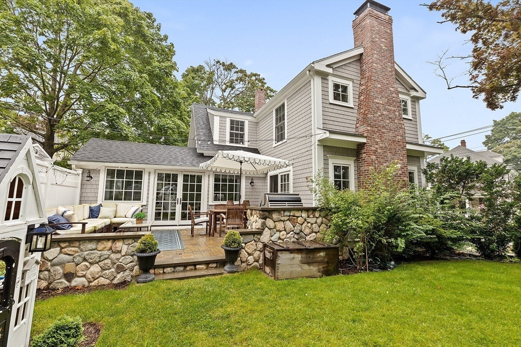 54 Elm Street Hingham, MA 02043 - Photo 28 of 33 a front view of a house with a garden and trees
