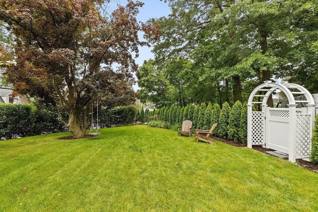 54 Elm Street Hingham, MA 02043 - Photo 30 of 33 a backyard of a house with table and chairs