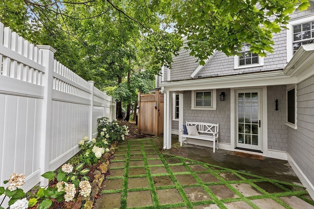 54 Elm Street Hingham, MA 02043 - Photo 31 of 33 a front view of a house with a garden