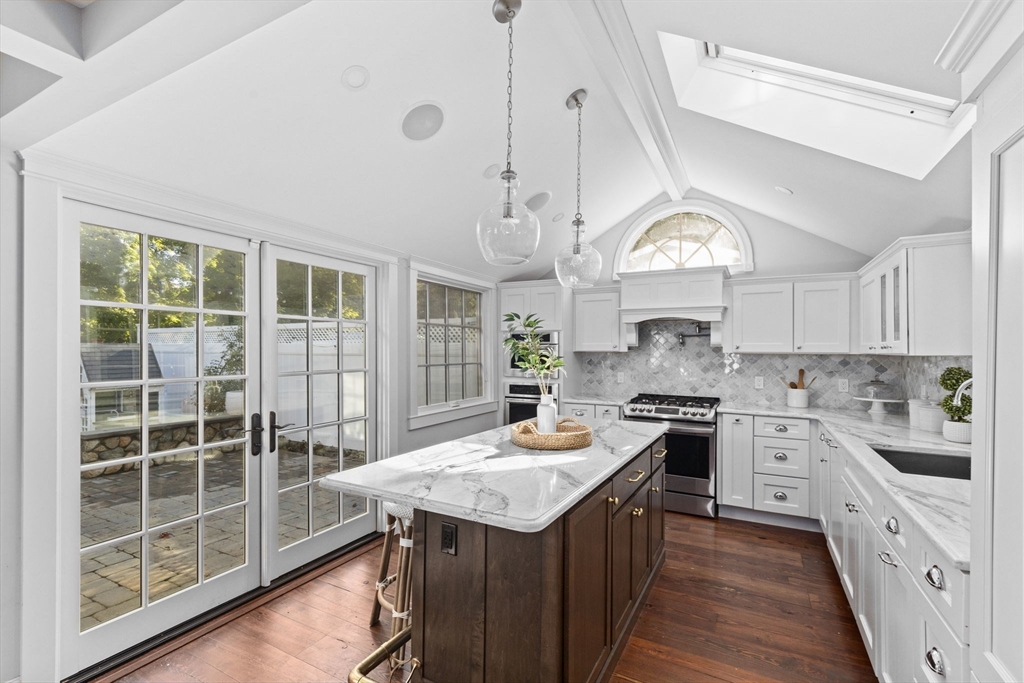 54 Elm Street Hingham, MA 02043 - Photo 4 of 33 a kitchen with kitchen island granite countertop a stove a kitchen island a sink and a stove