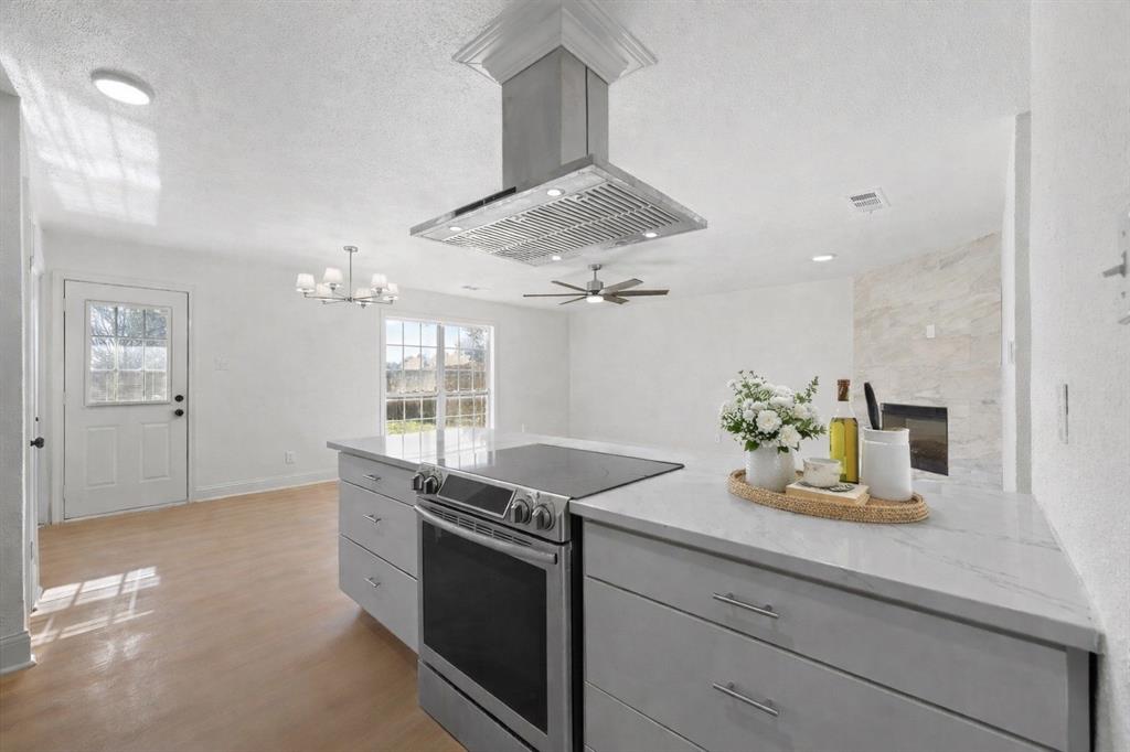 5516 Maple Lane Rowlett, TX 75089 - Photo 5 of 18 a kitchen with granite countertop a sink stainless steel appliances and cabinets