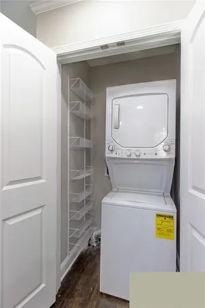 a view of cabinets stainless steel appliances wooden floor and a window