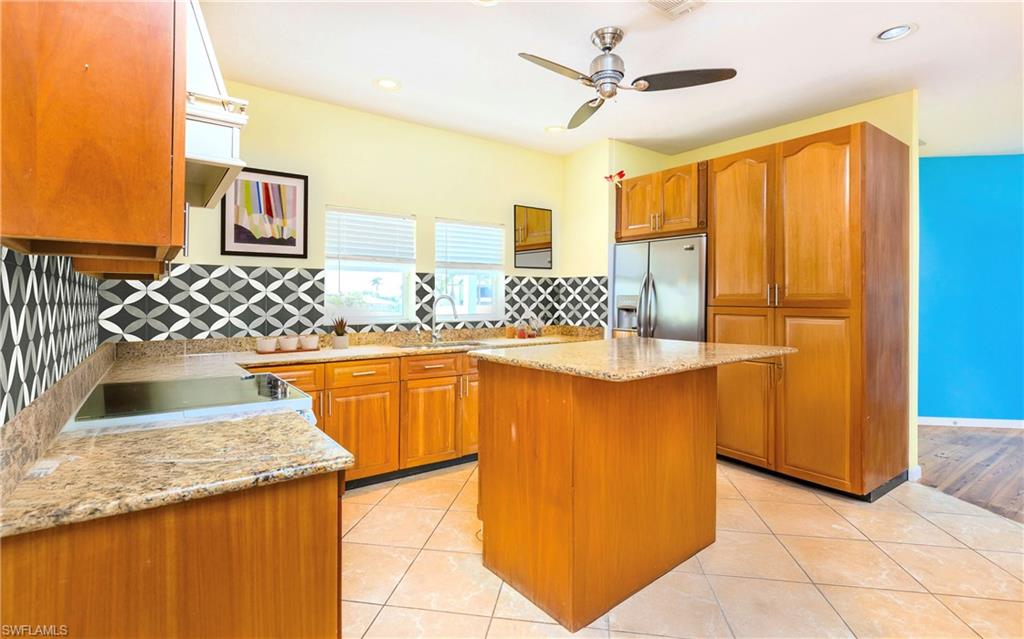 12277 Boat Shell Drive Matlacha Isles, FL 33991 - Photo 35 of 46 a kitchen with granite countertop sink and cabinets