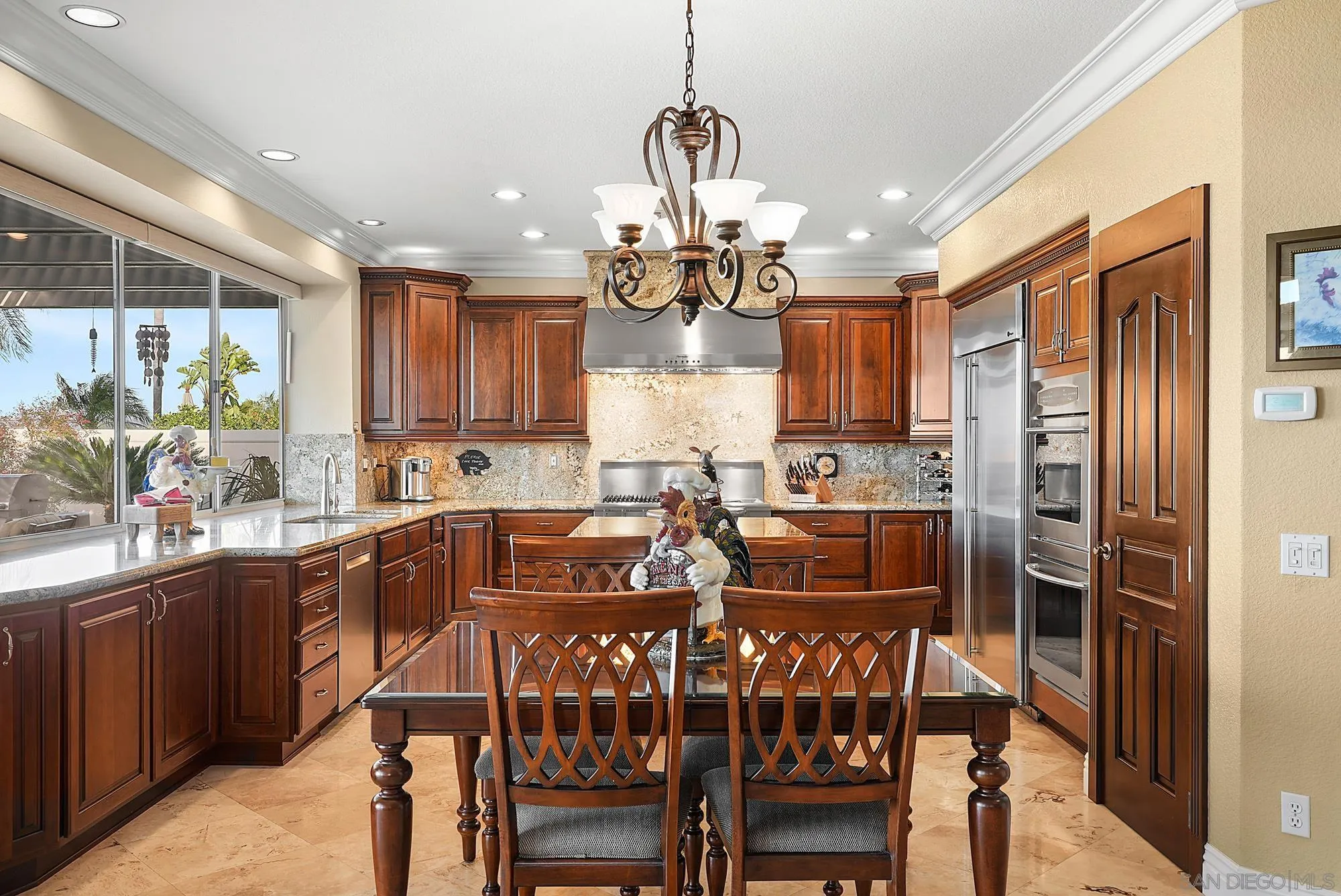 5028 Avenida De La Plata Oceanside, CA 92057 - Photo 18 of 68 a kitchen with stainless steel appliances granite countertop wooden floor dining table and chairs