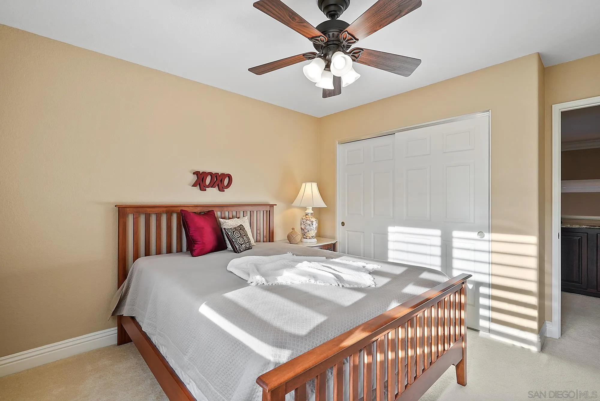 5028 Avenida De La Plata Oceanside, CA 92057 - Photo 39 of 68 a bedroom with a bed and a chandelier