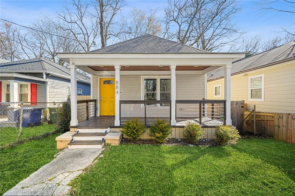 a view of a house with brick walls and a yard with plants