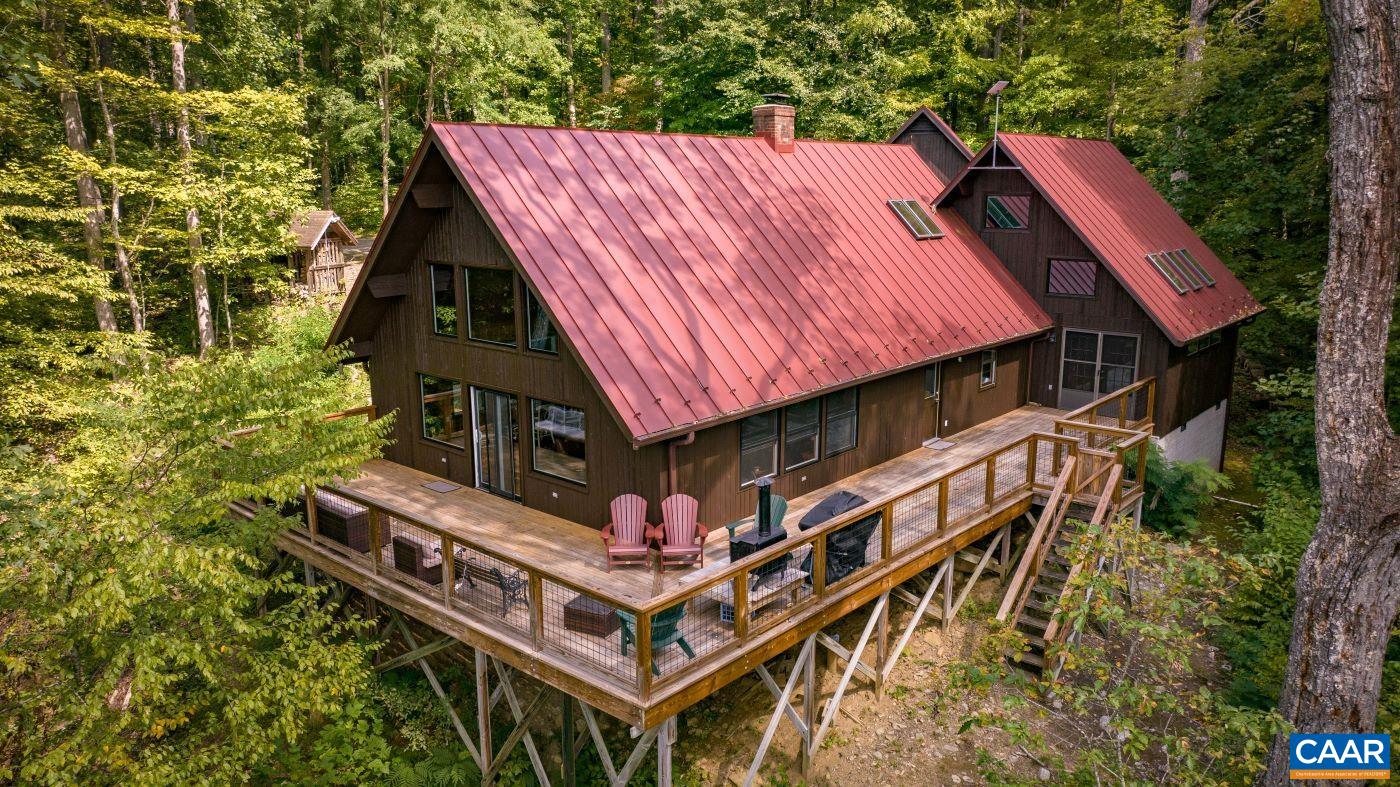 a roof deck with table and chairs under an umbrella