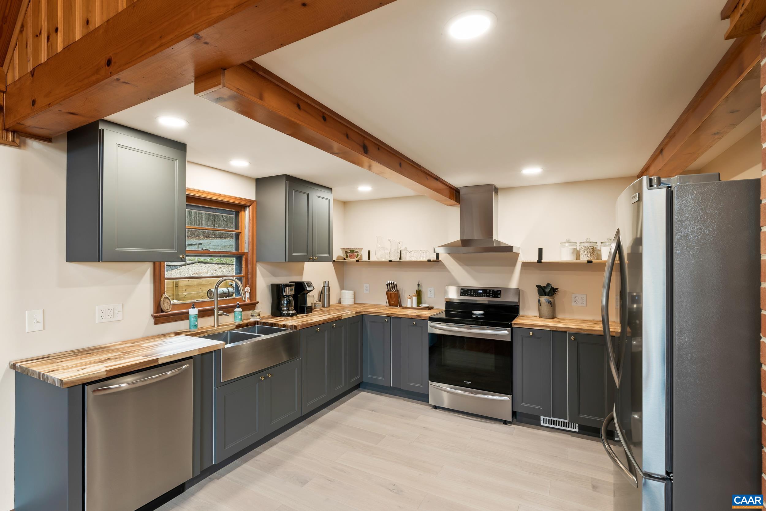 4496 Weakley Hollow Road Syria, VA 22743 - Photo 14 of 37 a kitchen with granite countertop a sink and stainless steel appliances