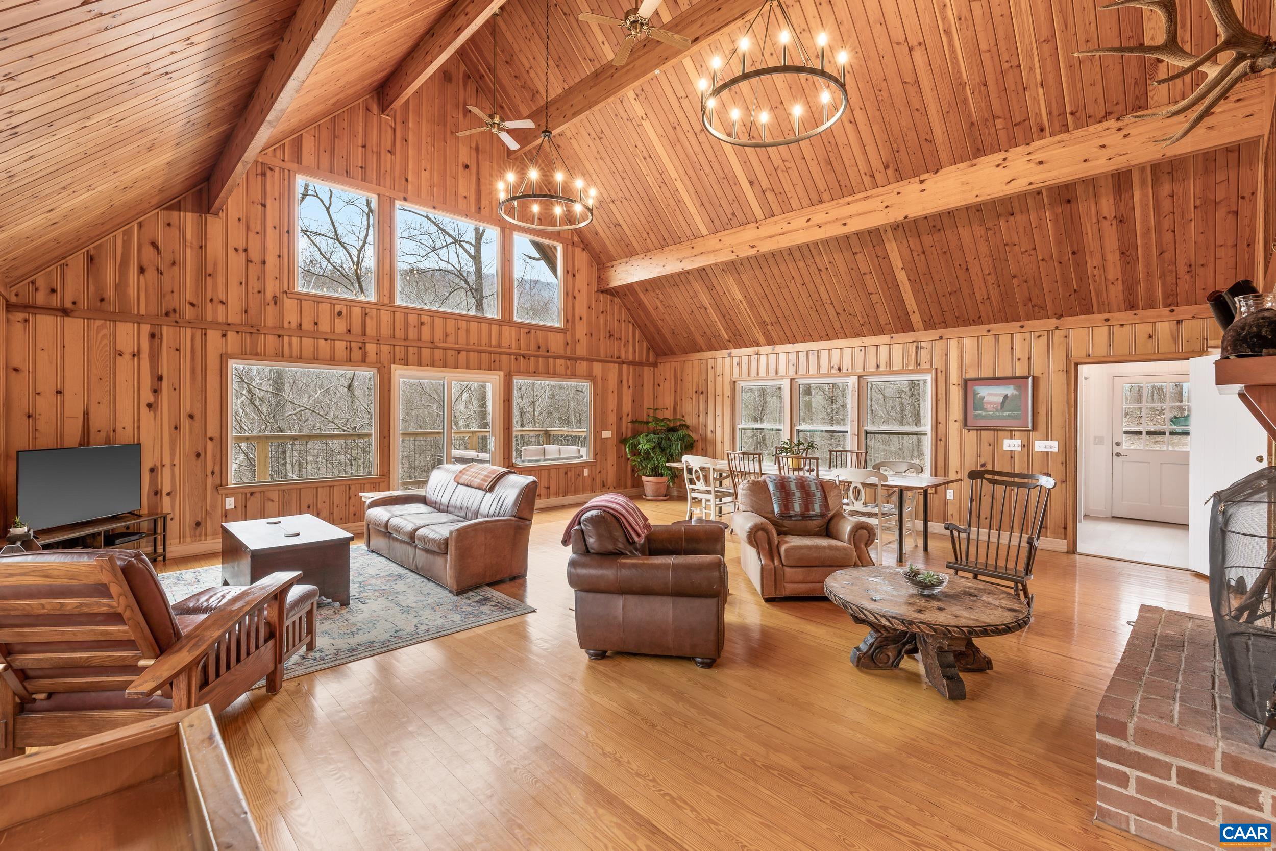 4496 Weakley Hollow Road Syria, VA 22743 - Photo 18 of 37 a living room with furniture and a floor to ceiling window