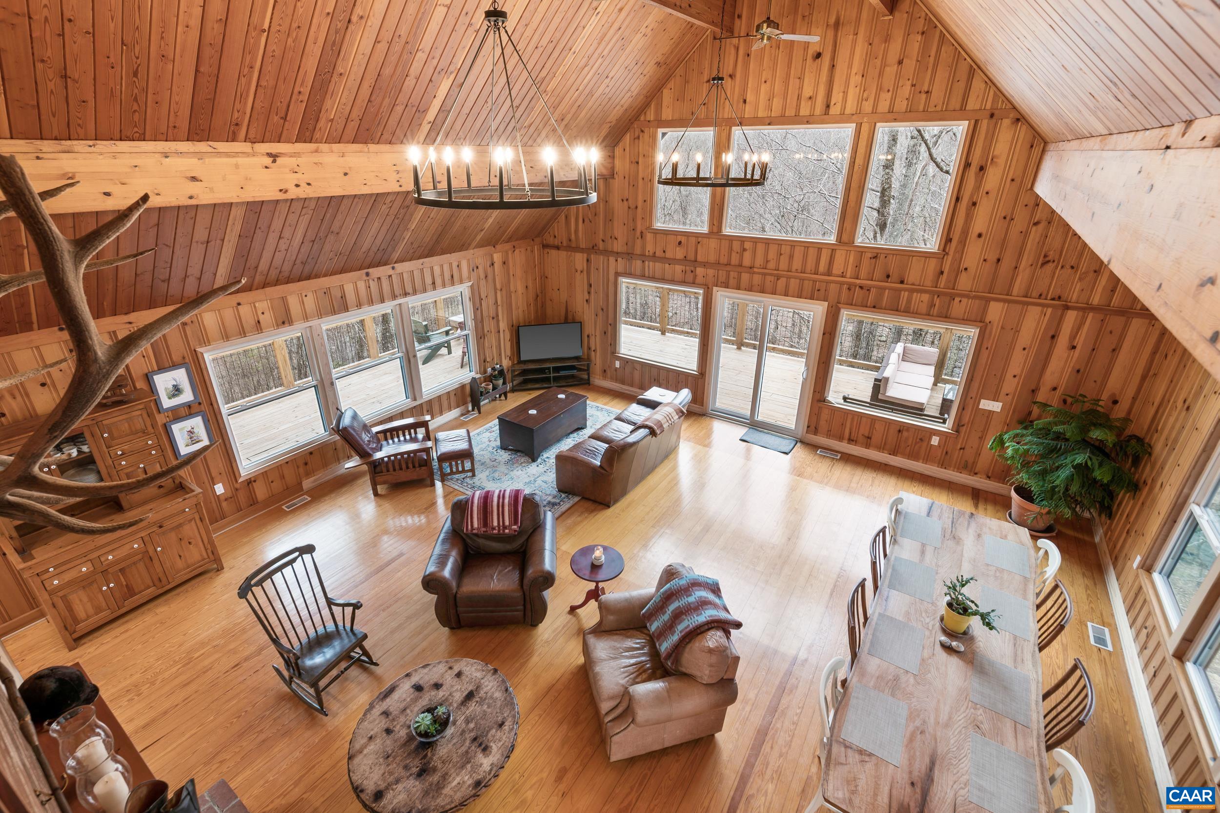 4496 Weakley Hollow Road Syria, VA 22743 - Photo 19 of 37 a living room with furniture and a floor to ceiling window