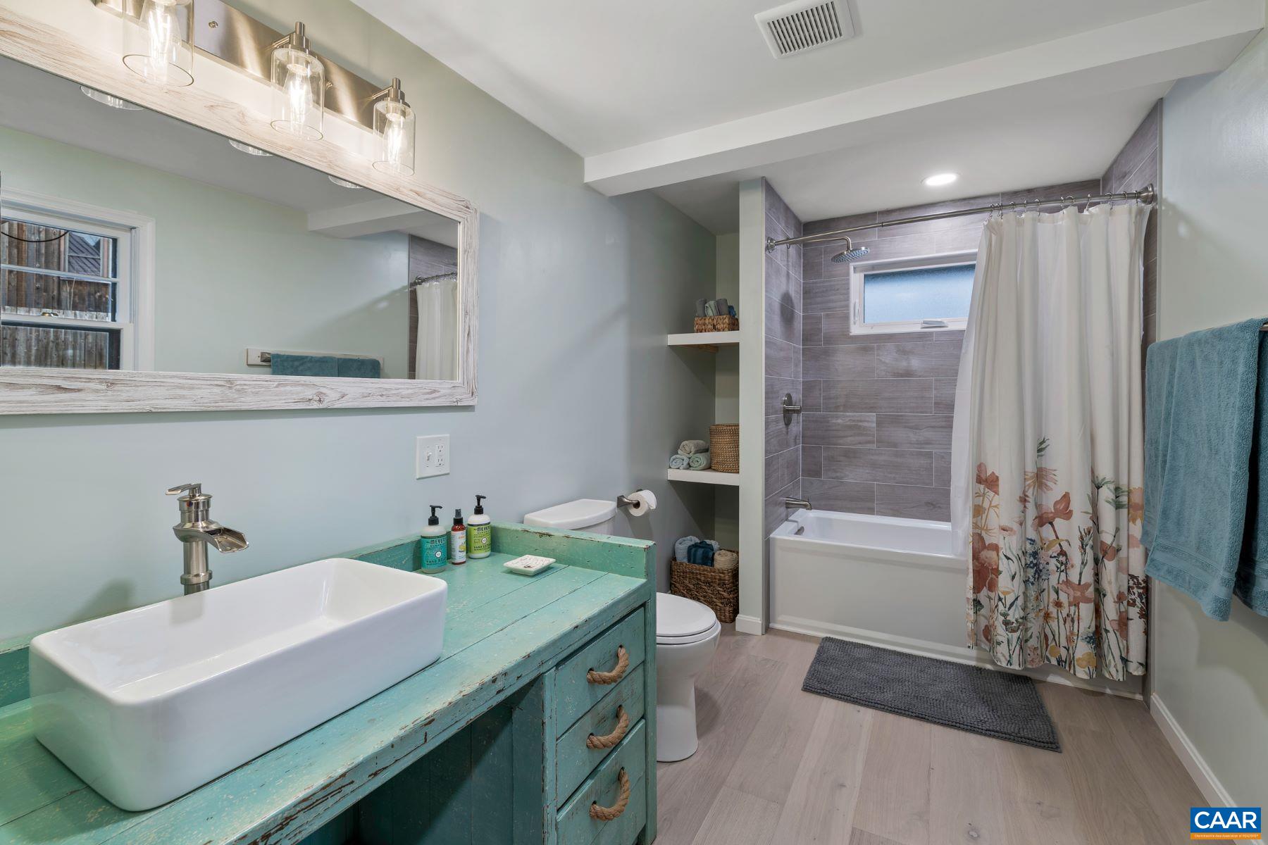 4496 Weakley Hollow Road Syria, VA 22743 - Photo 23 of 37 a bathroom with a sink a toilet and shower