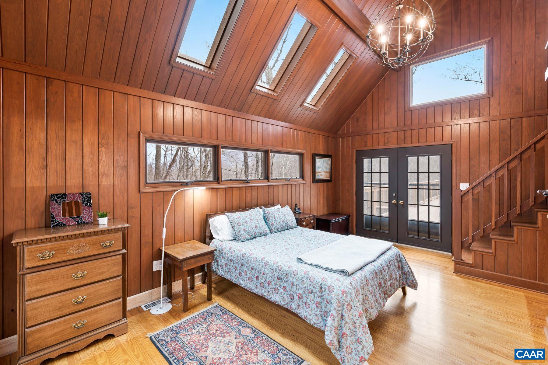 4496 Weakley Hollow Road Syria, VA 22743 - Photo 24 of 37 a bedroom with a bed and a dresser next to a window