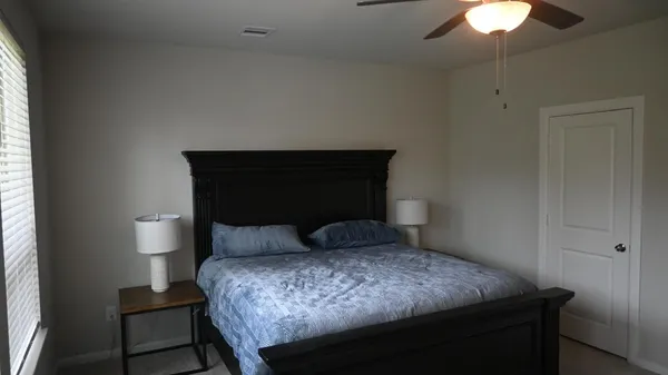 a bedroom with a bed and a chandelier