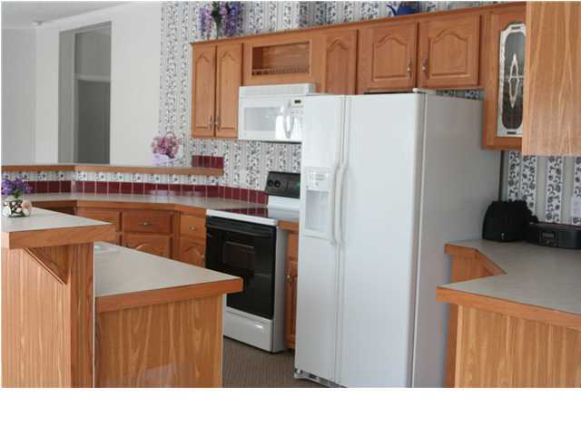 490 Long Road DeFuniak Springs, FL 32433 - Photo 14 of 22 a kitchen with stainless steel appliances a refrigerator and a stove