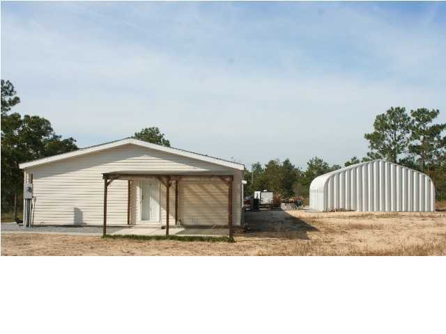 490 Long Road DeFuniak Springs, FL 32433 - Photo 20 of 22 a front view of a house with a yard