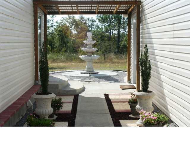 490 Long Road DeFuniak Springs, FL 32433 - Photo 4 of 22 a view of backyard of the house