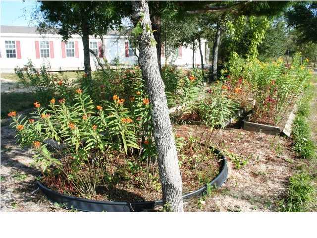 490 Long Road DeFuniak Springs, FL 32433 - Photo 8 of 22 a view of outdoor space and garden