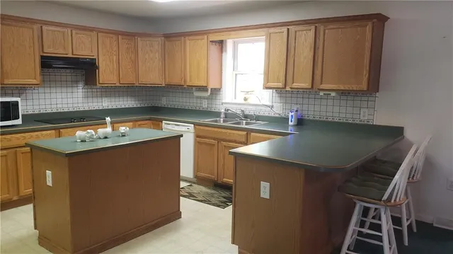 a kitchen with a sink stove and cabinets