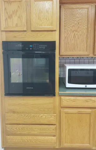 a stove top oven sitting inside of a kitchen