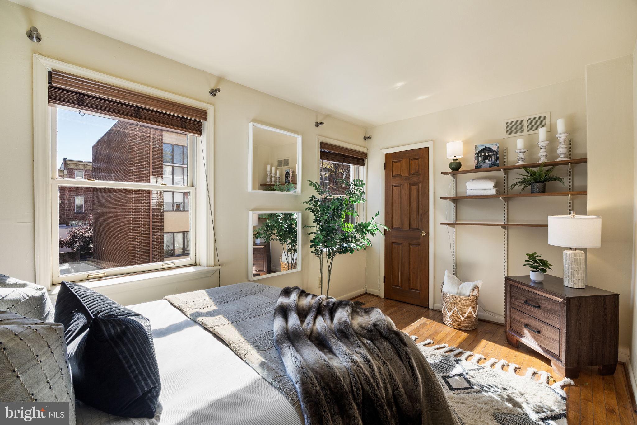 1905 Rodman Street Philadelphia, PA 19146 - Photo 13 of 22 a bedroom with a bed and wooden floor