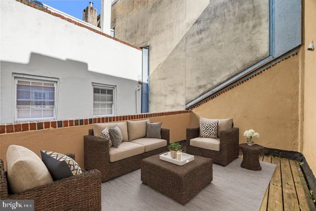 1905 Rodman Street Philadelphia, PA 19146 - Photo 16 of 22 a balcony with furniture and wooden floor