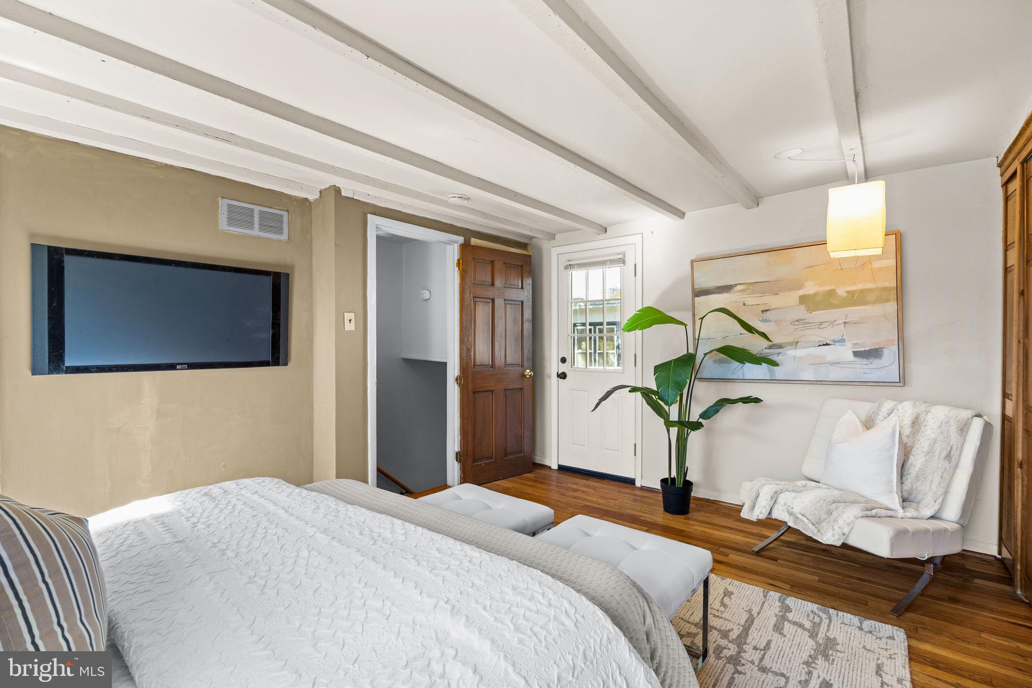 1905 Rodman Street Philadelphia, PA 19146 - Photo 18 of 22 a bedroom with a bed and wooden floor