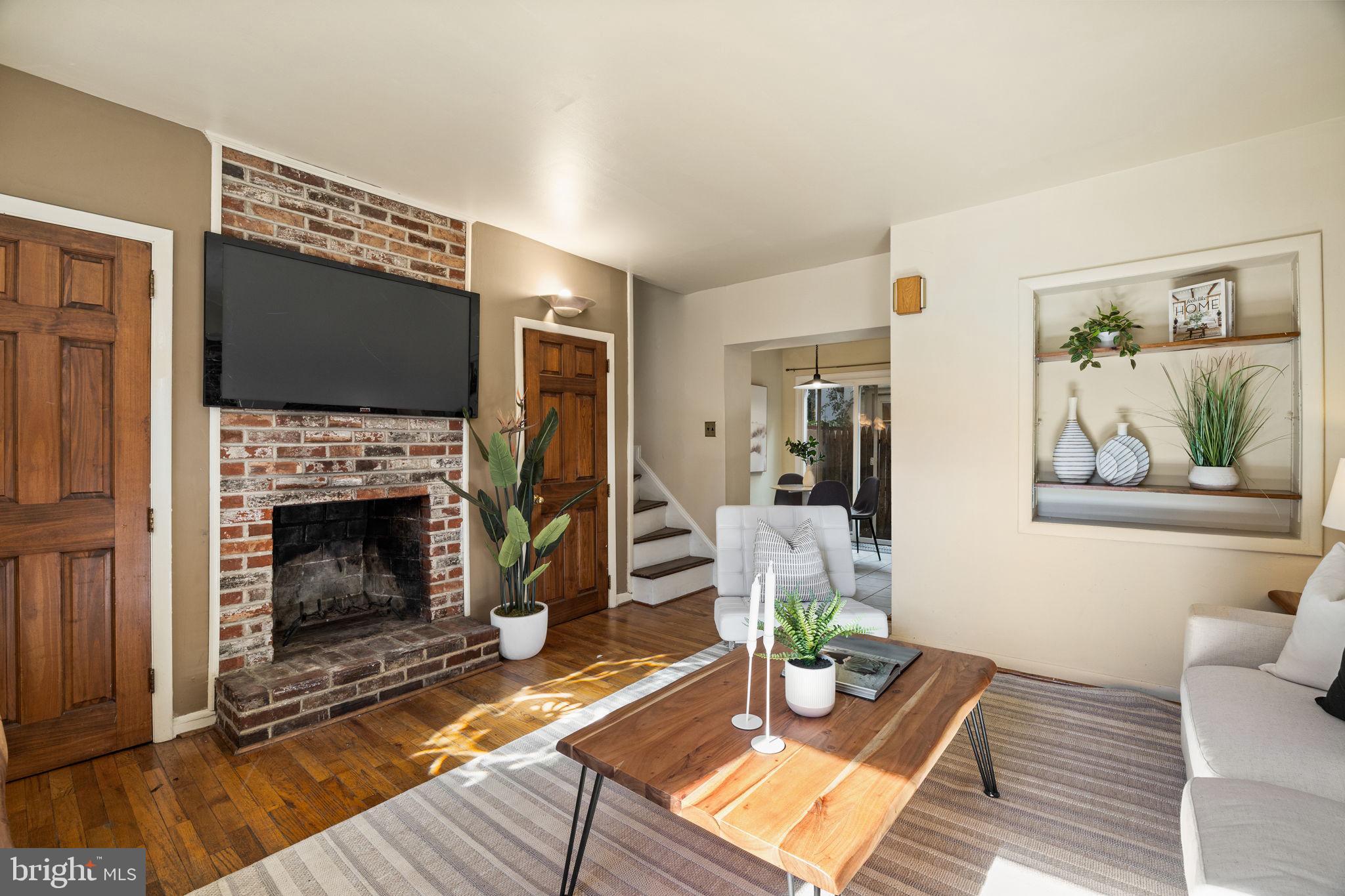 1905 Rodman Street Philadelphia, PA 19146 - Photo 3 of 22 a living room with furniture a flat screen tv and a fireplace