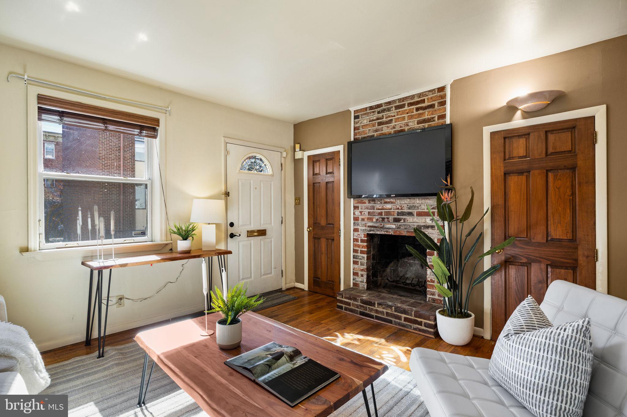 1905 Rodman Street Philadelphia, PA 19146 - Photo 4 of 22 a living room with furniture a fireplace and a flat screen tv